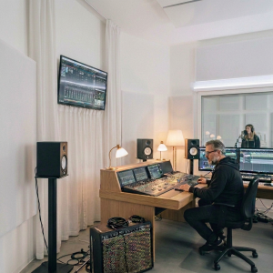 Sound engineer working at a mixing console in a recording studio